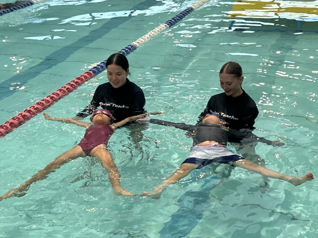 Teachers Helping Students Learn How To Float At Gunyama Teachers Helping Students Learn How To Float At Gunyama