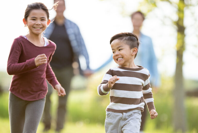 Adult And Child Running Together Outdoors On A Park Path 768x518