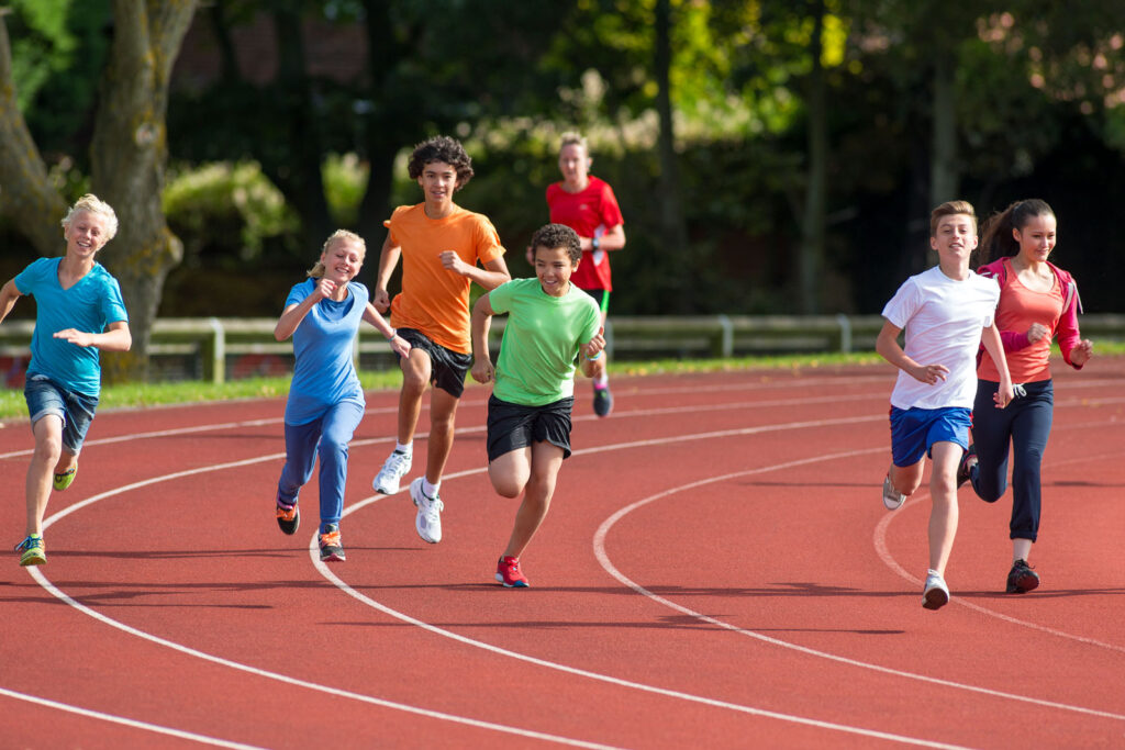 Children Running On An Outdoor Athletics Track