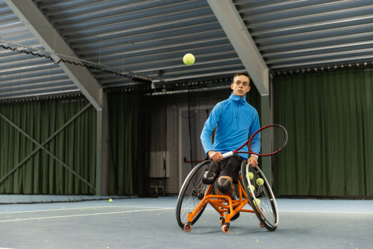 Person Using A Wheelchair In A Covered Outdoor Recreation Area 768x512
